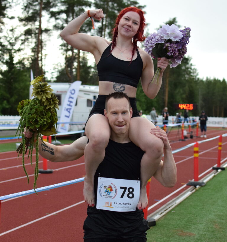 Teemu Tuovinen and Jatta Leinonen win the Wife Carrying sprint race in Sonkajärvi